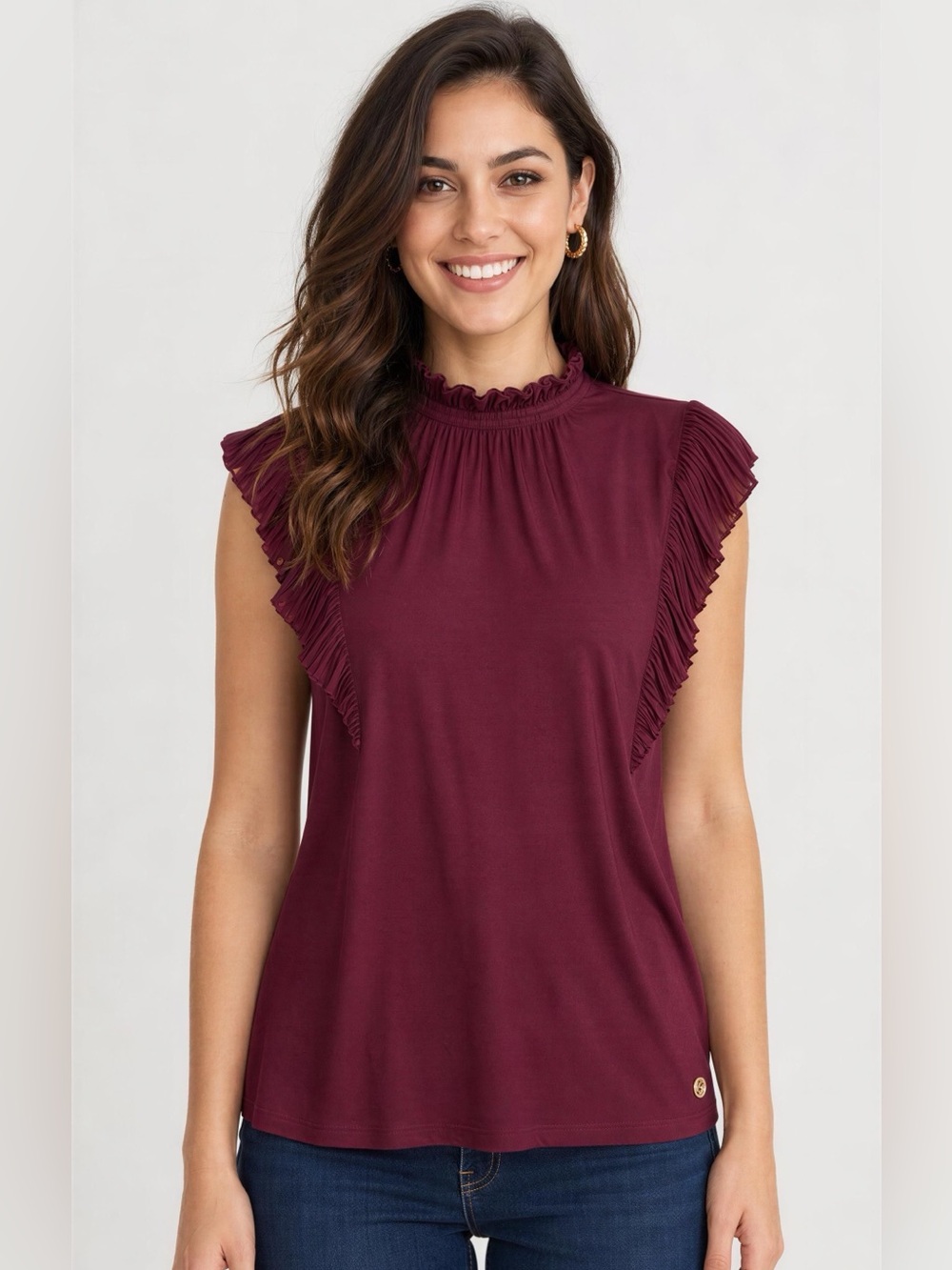 BCBG sleeveless burgundy top featuring a mock neck and ruffled sleeve details